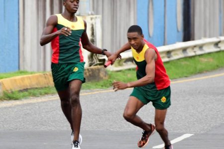 Matthew Gordon passing the baton to Marlon Nicholson on Sunday. The duo was part of the triumphant Guyana Defence Force (GDF) team which once again ran away with the first place trophy of the Inter-Services road relay event.
