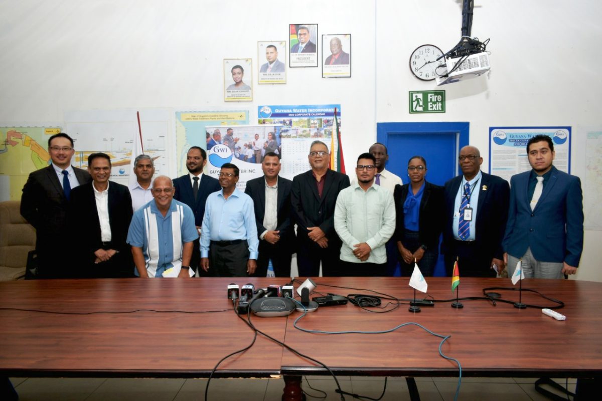 The contractors with officials from the government and GWI.