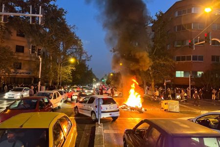 A police motorcycle burns during a protest over the death of Mahsa Amini, a woman who died after being arrested by the Islamic republic's "morality police", in Tehran, Iran September 19, 2022. WANA (West Asia News Agency) via REUTERS