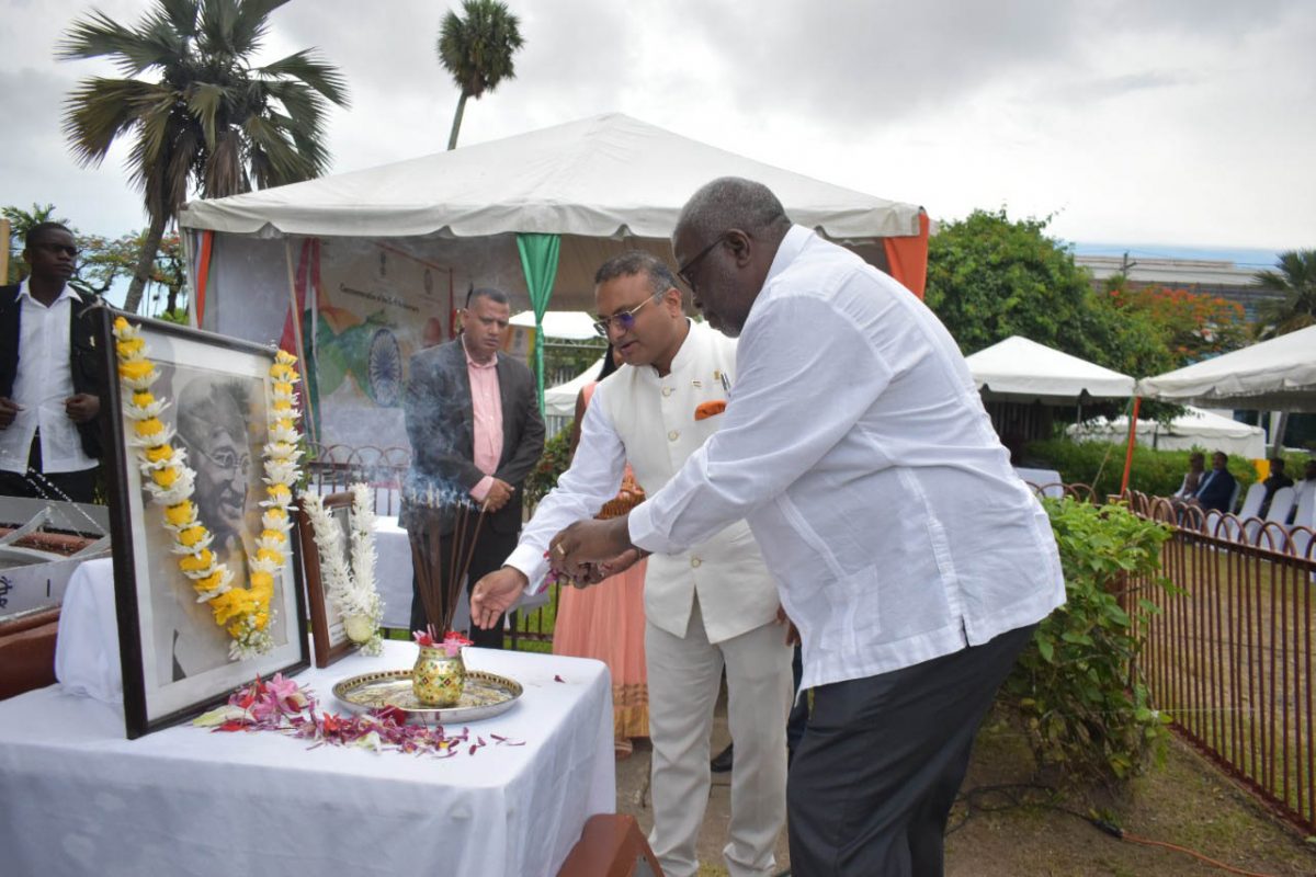 Prime Minister Mark Phillips (right) making an offering. Next to him is Indian High Commissioner to Guyana, Dr. K.J. Srinivasa. (Indian High Commission photo)