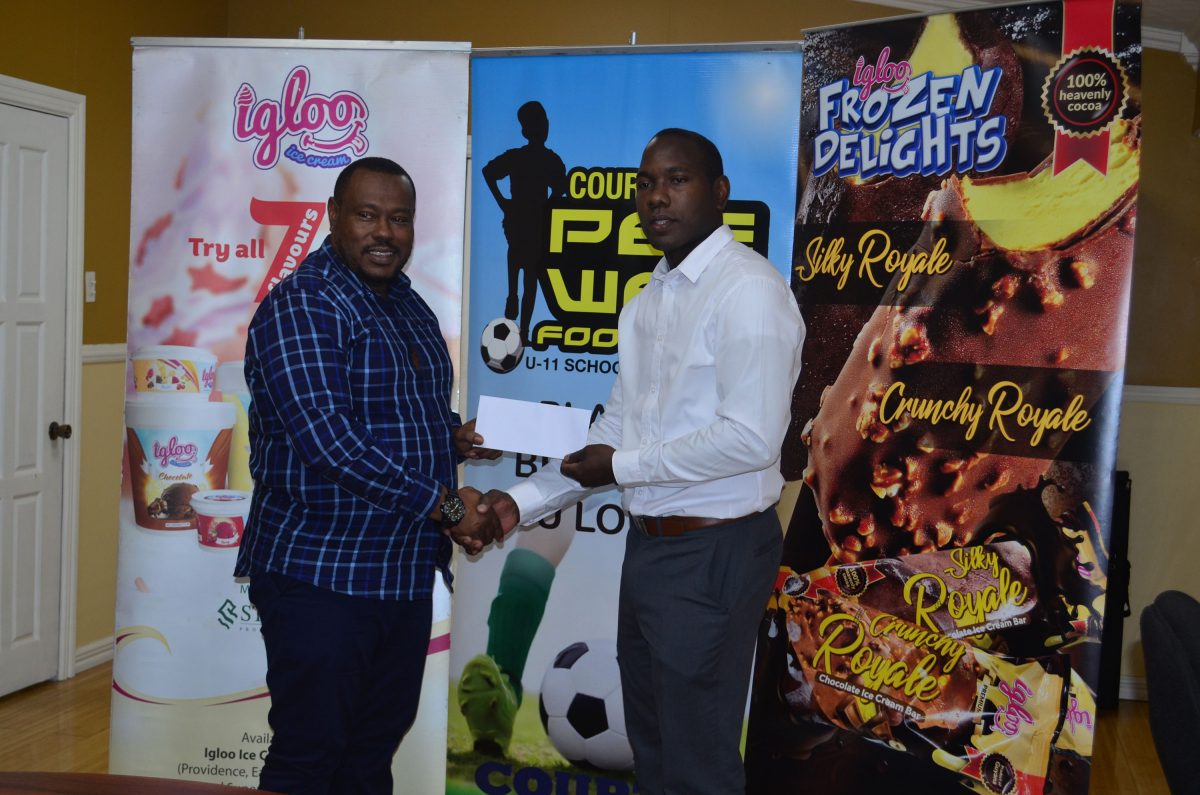 Petra Organization Co-Director Troy Mendonca (right), receiving the sponsorship cheque from Dellon Lynch, Marketing Manager of Sterling Products Ltd