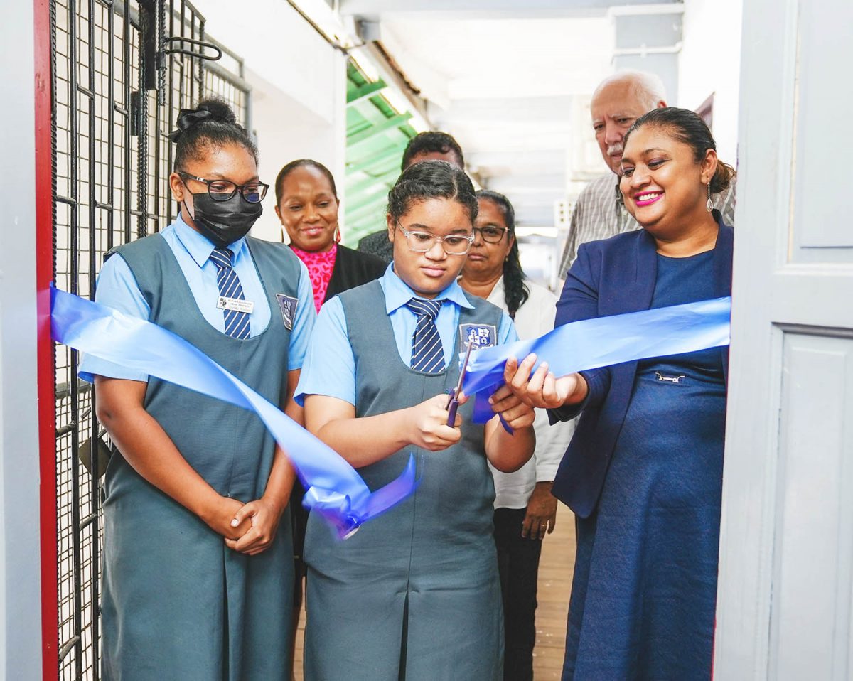 Minister Priya Manickchand (right) and a student cutting the ribbon for the smart room while the Headmistress and Chairman of the Board of Governors look on 