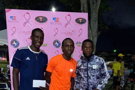 Caption Cleveland Thomas (centre), Winston Missigher (right) and Devaughn Barrington, finished 1, 2, 3 in the ‘Fireworks’ Golden Mile last evening. (Emmerson Campbell photo)