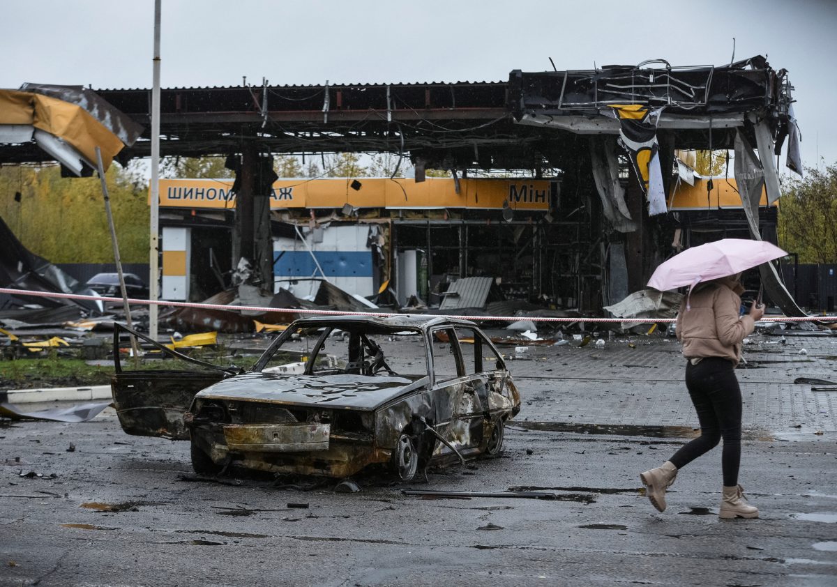 A woman passes by a gas station destroyed by yesterday’s Russian military strike, as Russia’s attack on Ukraine continues, in Dnipro October 26, 2022.  REUTERS/Mykola Synelnykov