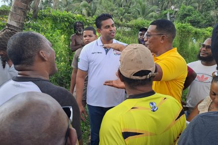 Minister of Culture Youth and Sports, Charles Ramson engaging residents of the Victor Valley commuinty during a vist to Linden yesterday. (DPI Photo)