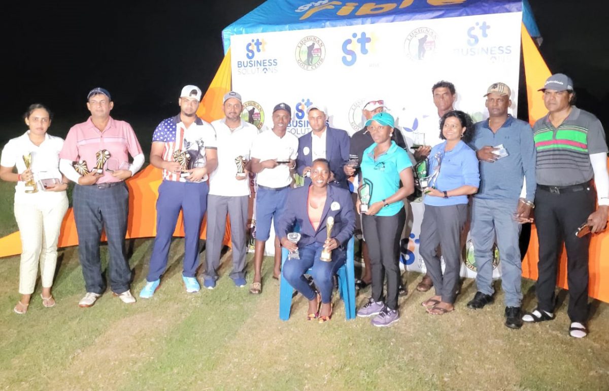 The various winners of the GTT Guyana Open pose for a photo opportunity with women’s champion, Shanella London seated and men’s champion, Avinash Persaud standing behind her.