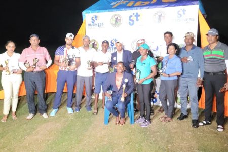 The various winners of the GTT Guyana Open pose for a photo opportunity with women’s champion, Shanella London seated and men’s champion, Avinash Persaud standing behind her.