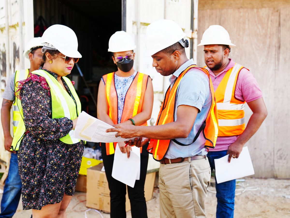 Minister Priya Manickchand (left) engaging Senior Projects Manager of the Ministry, Ron Eastman and representatives of the contracting firm and the consultant at the Yarrowkabra site. (Ministry of Education photo)
