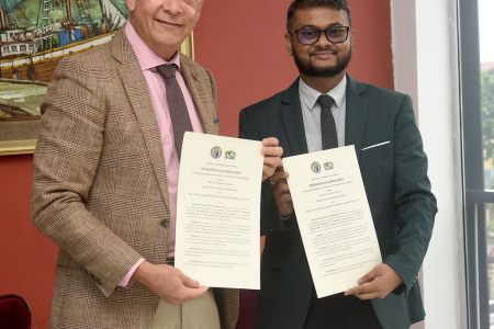 Port-of-Spain Mayor Joel Martinez, left, and Georgetown Mayor Pandit Ubraj Narine after the signing of a MoU at the Port-of-Spain City Corporation yesterday.