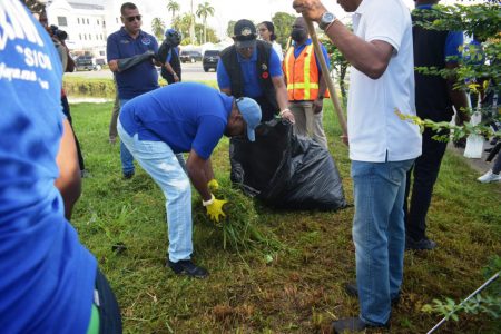 Although there has been improvement in the state of cleanliness across the city, President Irfaan Ali has said that “heavy” focus will be placed on enforcement to ensure that it is maintained. His comments came following the start of the latest National Cleanup exercise yesterday morning. Ali is seen in photo (at centre) doing his part during the cleanup. See more on page 18 (Office of the President photo)