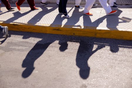 Cuban migrants, who were expelled from the U.S. and sent back to Mexico under Title 42, walk near the at the Lerdo Stanton International border bridge, in Ciudad Juarez, Mexico May 3, 2022. REUTERS/Jose Luis Gonzalez/File Photo