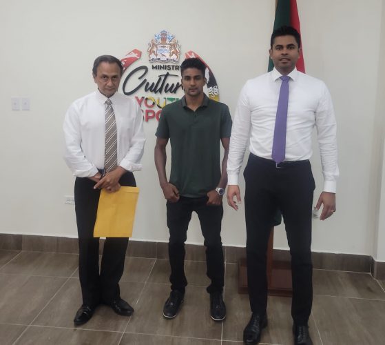 Elton Dharry (centre) earlier this year posing with president of the local boxing board, Peter Abdool (left) and Minister of Sport, Charles Ramson Jr
