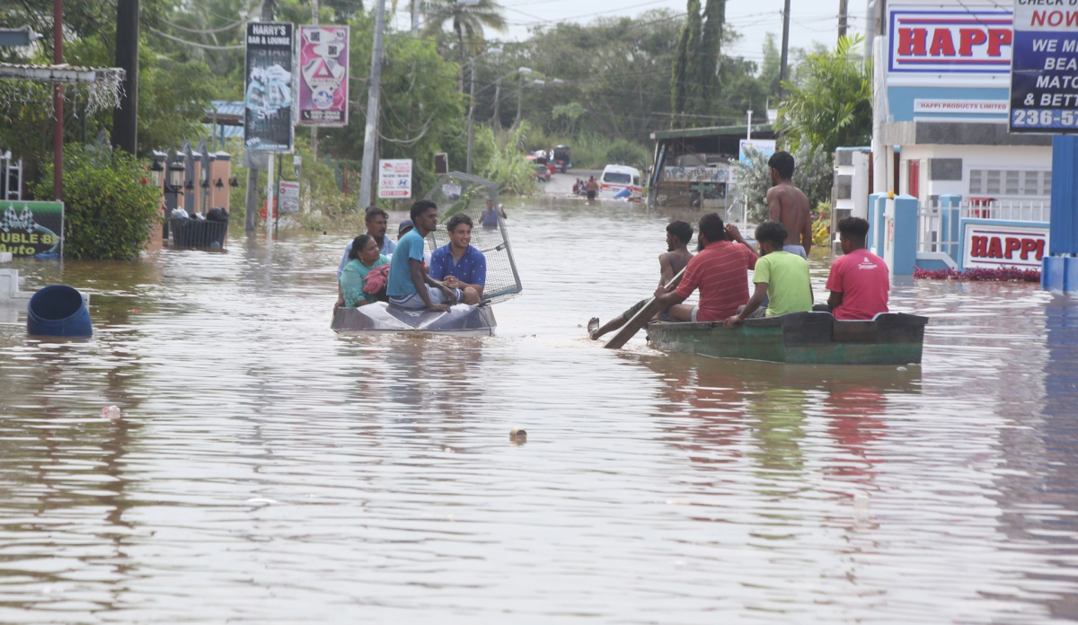 Bamboo Settlement #2 residents use boats to move around as floodwater continued to rise in their area yesterday.