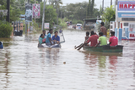Bamboo Settlement #2 residents use boats to move around as floodwater continued to rise in their area yesterday.