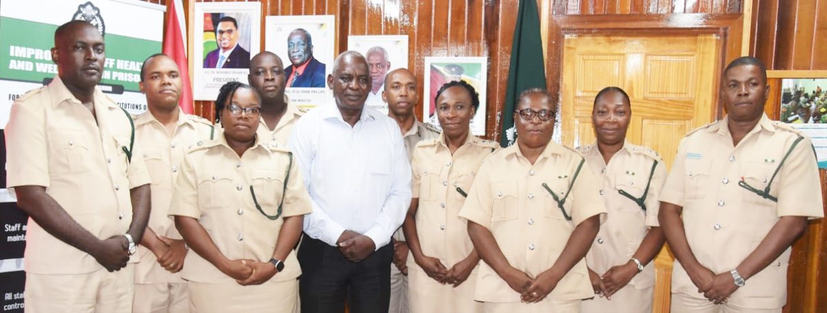 The newly promoted prison officers with Minister of Home Affairs Robeson Benn 