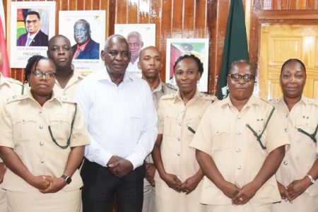 The newly promoted prison officers with Minister of Home Affairs Robeson Benn 