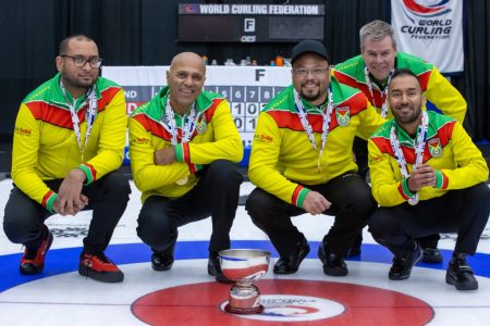 Team Guyana posing with their medals and championship trophy after winning the B-Division in the Inaugural Pan Continental Curling Championship
