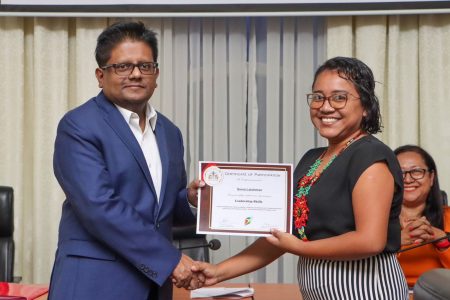 Finance Minister Ashni Singh presenting a certificate of participation to Bethany Village toshao Sonia Latchman (DPI photo) 