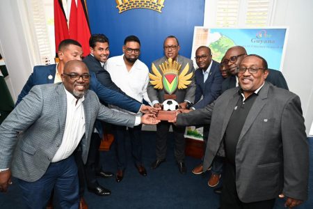 President Irfaan Ali, along with Minister of Culture, Youth and Sport, Charles Ramson Jr, Executives of the GFF, and other football stakeholders display the One Guyana President’s Cup trophy