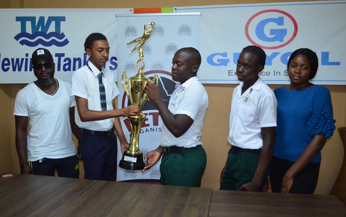 Captain of Christianburg/Wismar Secondary Devon Gilbert (2nd from left), and Golden Grove skipper Kellon Croal (3rd from right) squaring off with the trophy in the presence of Christianburg/Wismar Secondary head-coach Dellon Peters (left) and Golden Grove Manager Shenika Griffith