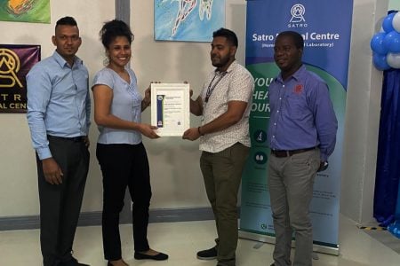 Mahesh and Marina Itwaru receiving their certification from GNBS staff at a ceremony on Thursday 