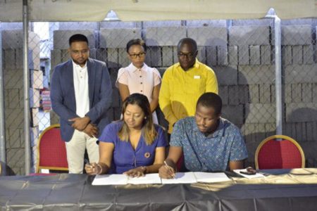 Permanent Secretary of the Local Government Ministry Prema Ramahah-Roopnarine and Chairman of the North Sophia Community Development Council (CDC), Uriah France signing the contract (DPI photo) 