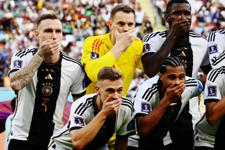 Germany players cover their mouths as they pose for a team
group photo before the match REUTERS/Annegret Hilse