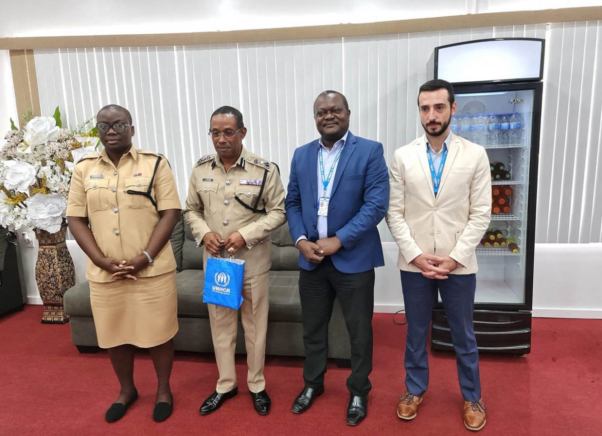 Acting Commissioner of Police Clifton Hicken (second from left) with Henri-Sylvain Yakara, Head of the National Office United Nations High Commissioner for Refugees in Guyana (second from right) and others.