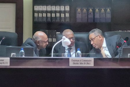Chairman of the CoI, retired Justice Stanley John (centre) and two Commissioners, Justice Godfrey Smith (right) and retired Justice Carl Singh engaged in a discussion while Jonathan Yearwood was giving evidence. 