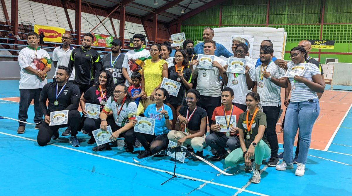 The respective winners and top three finishers pose with the spoils following the conclusion of the 2022 National Archery Indoor Championships at the National Gymnasium on Mandela Avenue