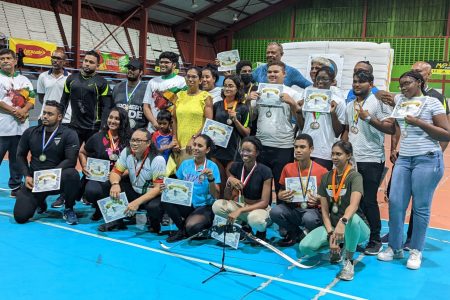 The respective winners and top three finishers pose with the spoils following the conclusion of the 2022 National Archery Indoor Championships at the National Gymnasium on Mandela Avenue