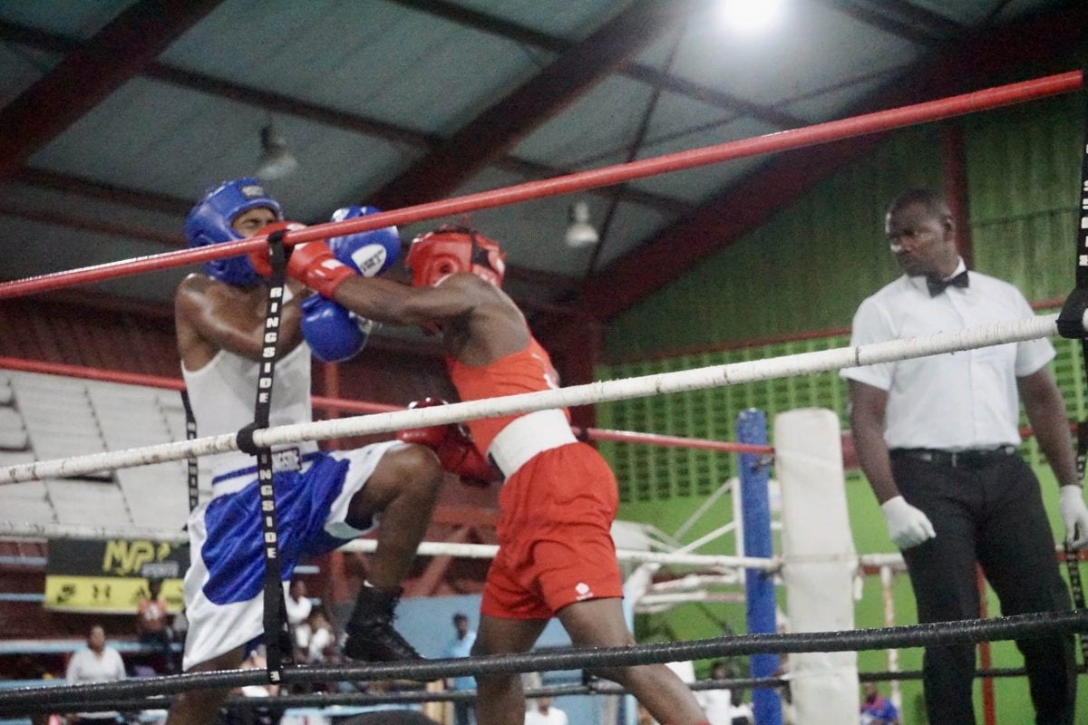 Patrick Harvey (right) of the Forgotten Youth Foundation (FYF) gym lands a hard left hand against Republican’s Steffan Caesar. Harvey went on to win the junior welterweight bout via a first round stoppage.  (Emmerson Campbell photo)