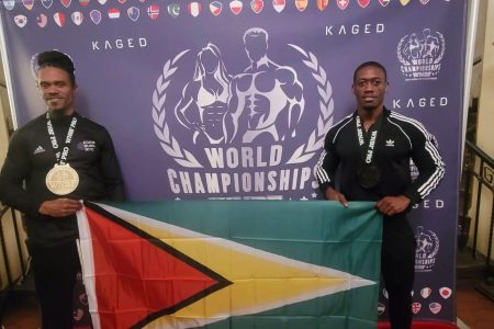 Decorated bodybuilder, Kerwin Clarke (right) and Master’s Rawle Green pose with the Golden Arrowhead on Sunday following the World Natural Bodybuilding Federation (WNBF) World Championship which was staged in Los Angeles, California, USA.
