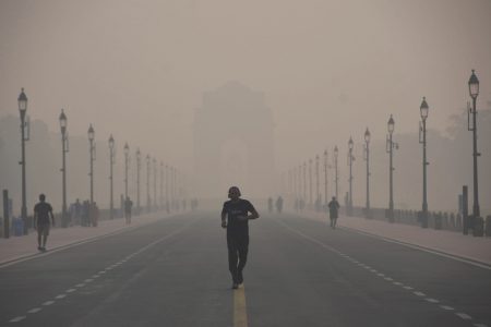 A man jogs through heavy smog conditions in New Delhi ,on Nov. 1, 2022.