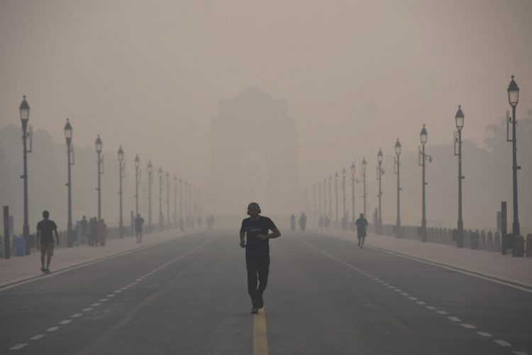 A man jogs through heavy smog conditions in New Delhi ,on Nov. 1, 2022.