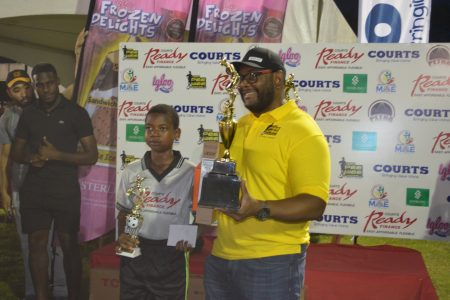 HGS and MVP of the tournament Jayshan Haynes receiving his prizes from Richard Allan, Courts Director of Consumer Finance.