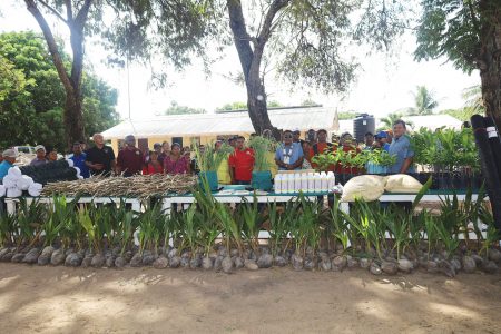 Farmers from the sixteen villages with the inputs which were distributed.  (Ministry of Agriculture photo)