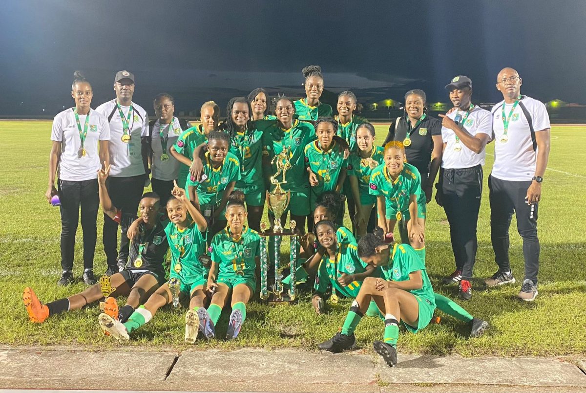 Champions! The victorious Guyana team posing with their spoils after defeating Suriname in the IGG Football Final.