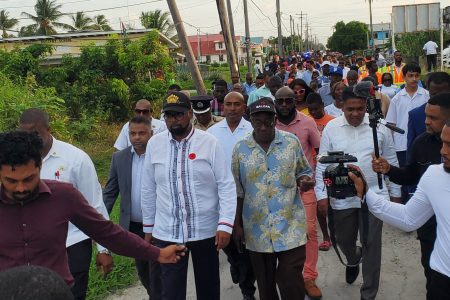 President Irfaan Ali (second from left) yesterday visited Den Amstel on the West Coast of Demerara where he met with residents and listened to their issues. (Ministry of Public Works photo)