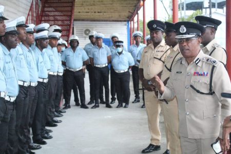 Commissioner of Police (ag) Clifton Hicken (right) addressing members of the police force yesterday. (GPF photo)