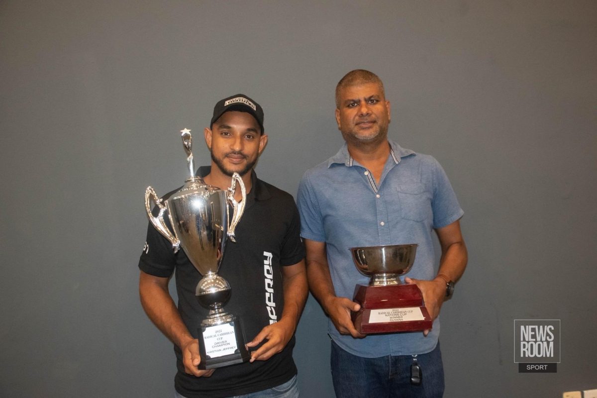 2022 Radical Caribbean Cup champion, Kristian Jeffrey and GMR&SC president, Mahendra Boodhoo, poses with the coveted trophies. (Newsroom photo)