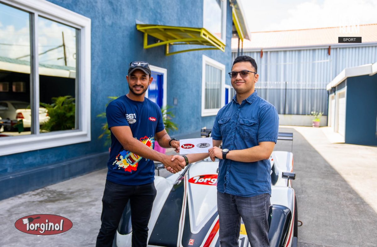 Kristian Jeffrey (left) receives the sponsorship cheque from Sachin Puri from Continental Group of Companies, the manufacturers of Torginol Paints.