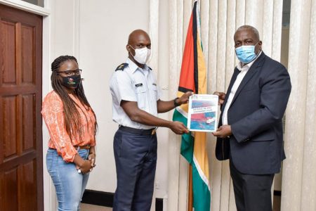 Prime Minister, Mark Phillips (right) receiving a copy of the National Oil Spill Contingency Plan on October 3rd 2020 from then Director General of the Civil Defence Commission (CDC), Lieutenant Colonel Kester Craig in the boardroom of the Office of the Prime Minister, Colgrain House, Camp Street, Georgetown. Also pictured is Project Manager, Civil Defence Commission, Anita Wilson.  (DPI photo)