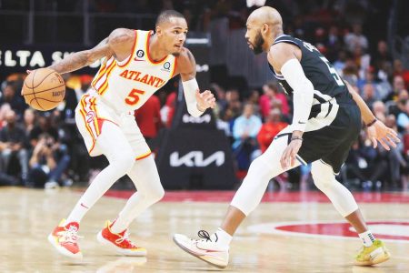 Atlanta Hawks guard Dejounte Murray (5) is defended by Milwaukee Bucks guard Jevon Carter (5) in the second quarter at State Farm Arena. Mandatory Credit: Brett Davis-USA TODAY Sports.
