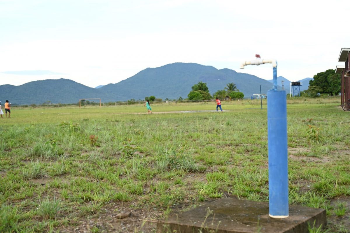 A stand pipe at right as children play on a field (CHPA photo)