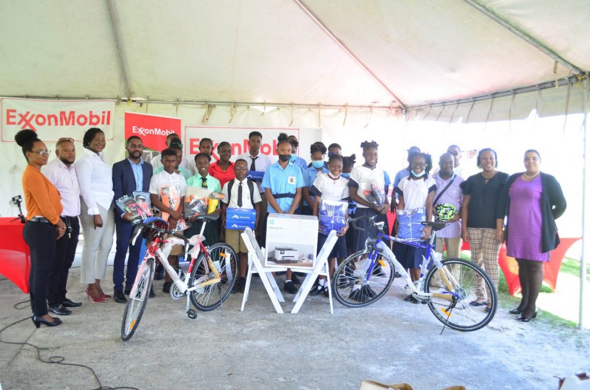 The top four finishers from the recent ExxonMobil Football Championships  display their prizes in the presence of tournament officials and representatives from the event sponsor.
