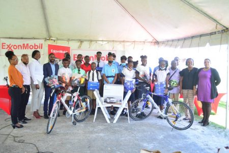 The top four finishers from the recent ExxonMobil Football Championships  display their prizes in the presence of tournament officials and representatives from the event sponsor.
