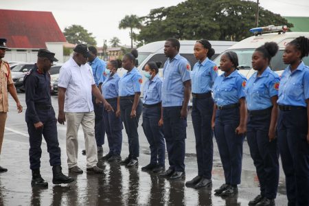 Minister of Home Affairs, Robeson Benn (second from left), yesterday inspected the ranks of the Guyana Fire and Rescue Service during a muster exercise to ensure they are properly kitted out with the necessary protective gear and equipment. A release from the Ministry of Home Affairs said that over 200 senior and junior ranks as well as Emergency Medical Technicians from the Central, Leonora, La Grange, Alberttown, West Ruimveldt, Campbellville, Eccles, Diamond, Melanie, Mahaica, Timehri, New Amsterdam, Anna Regina, Mahdia and Lethem fire stations braved the rainy weather to be part of the exercise which was conducted in all divisions.
(Ministry of Home Affairs photo)