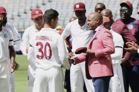 Guyana’s Tagenarine Chanderpaul is presented with his test cap by Brian Lara.