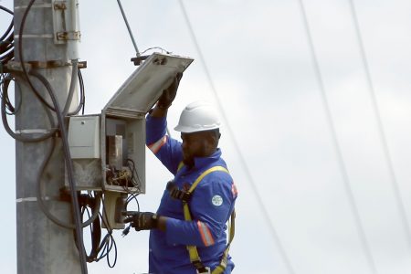 File: A technician is seen carrying out repair works on a CCTV camera at the intersection of Mausica Road and the Churchill Roosevelt Highway in July.
